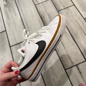 Nike White and Black Sneakers with Gold Accents